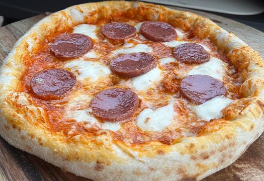 Geweldige pizza met salami gemaakt in de Pizza oven